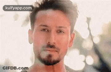 A Close Up Of A Man 'S Face With A Beard . GIF