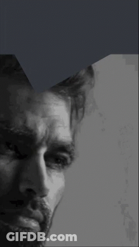 A Close Up Of A Man 'S Face With A Beard In A Black And White Photo GIF