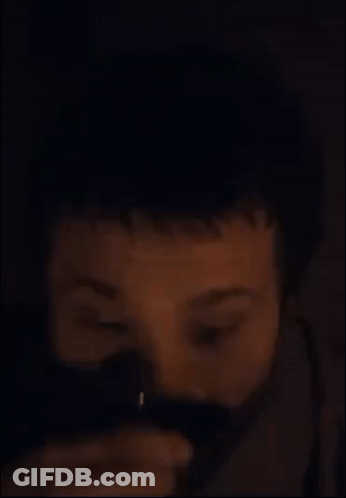 A Close Up Of A Man 'S Face With A Beard In The Dark GIF