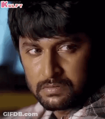 A Close Up Of A Man 'S Face With A Beard Looking At The Camera . GIF