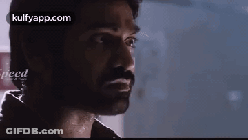 A Close Up Of A Man 'S Face With A Beard Looking At The Camera . GIF