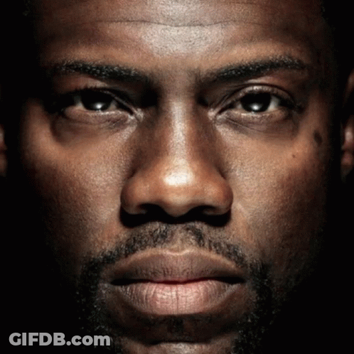 A Close Up Of A Man 'S Face With A Beard Looking At The Camera GIF