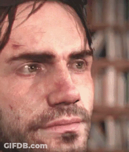 A Close Up Of A Man 'S Face With A Beard Looking At The Camera GIF