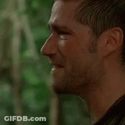 A Close Up Of A Man 'S Face With A Beard Looking At The Camera . GIF