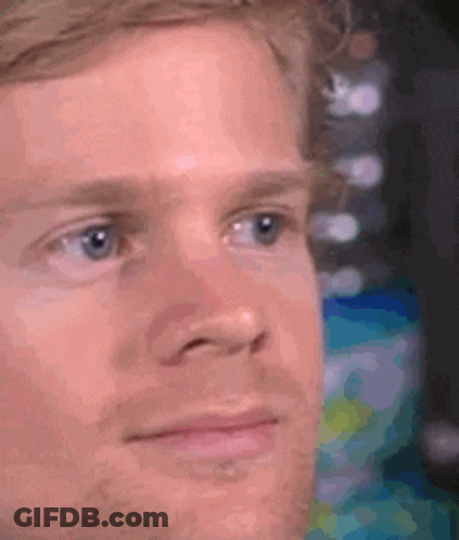 A Close Up Of A Man 'S Face With A Beard Looking At The Camera . GIF