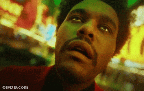 A Close Up Of A Man 'S Face With A Beard Looking Up At The Sky . GIF