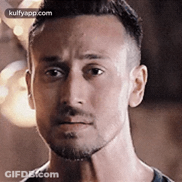 A Close Up Of A Man 'S Face With A Beard Making A Serious Face . GIF