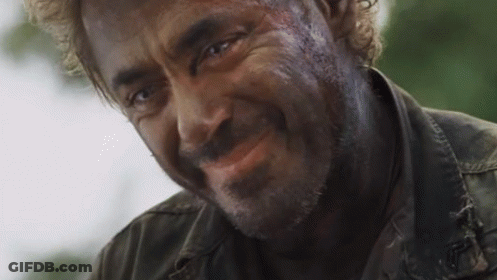 A Close Up Of A Man 'S Face With A Beard Smiling . GIF