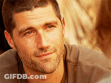 A Close Up Of A Man 'S Face With A Beard Smiling GIF