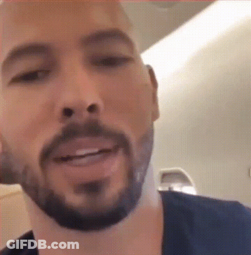 A Close Up Of A Man 'S Face With A Beard Smiling GIF