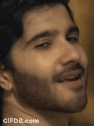 A Close Up Of A Man 'S Face With A Beard Smiling GIF