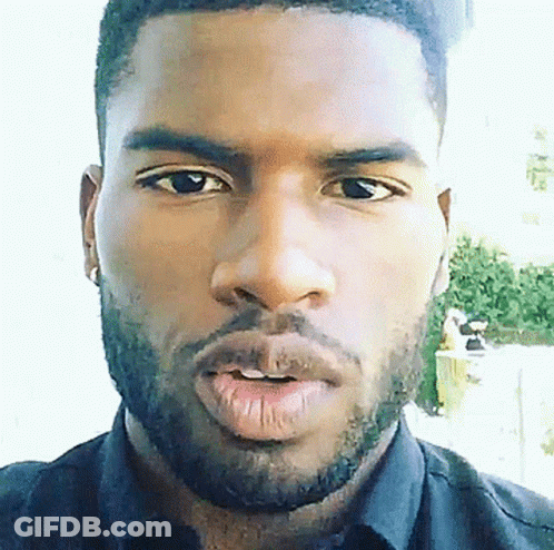 A Close Up Of A Man 'S Face With A Beard Wearing A Black Shirt GIF