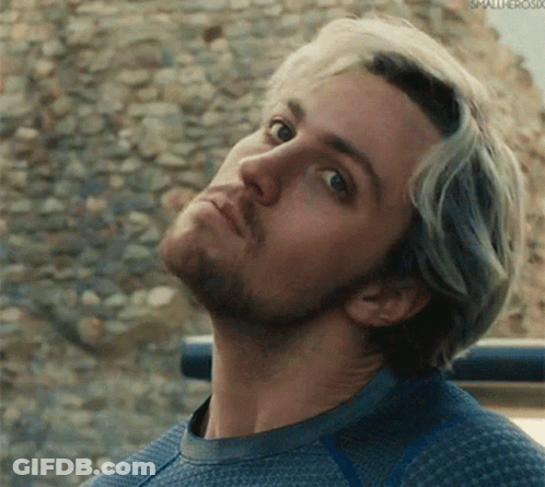 A Close Up Of A Man 'S Face With A Beard Wearing A Blue Sweater . GIF