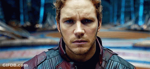 A Close Up Of A Man 'S Face With A Beard Wearing A Leather Jacket . GIF