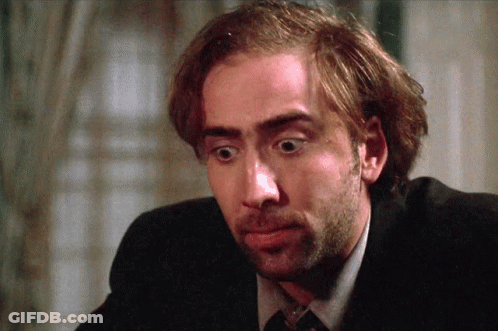 A Close Up Of A Man 'S Face With A Beard Wearing A Suit And Tie GIF