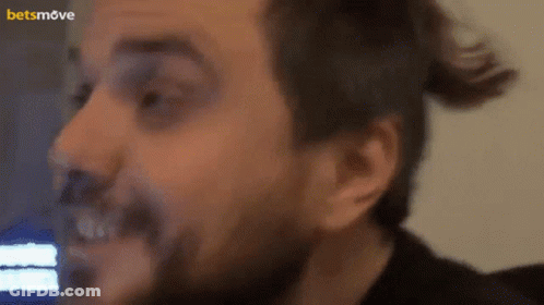 A Close Up Of A Man 'S Face With A Betsmove Logo In The Corner GIF