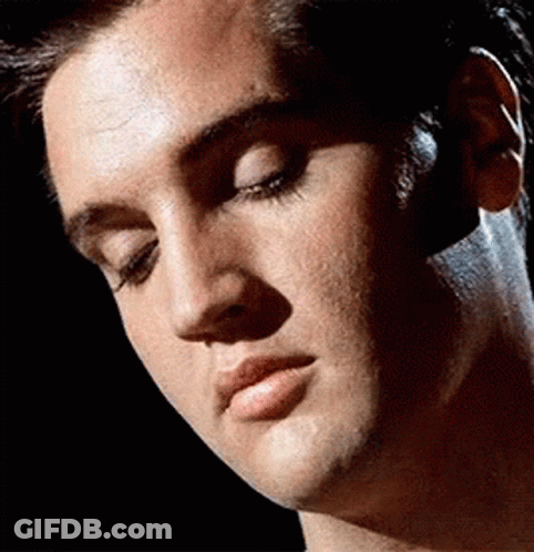 A Close Up Of A Man 'S Face With A Black Background GIF