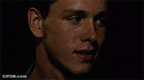 A Close Up Of A Man 'S Face With A Black Background GIF