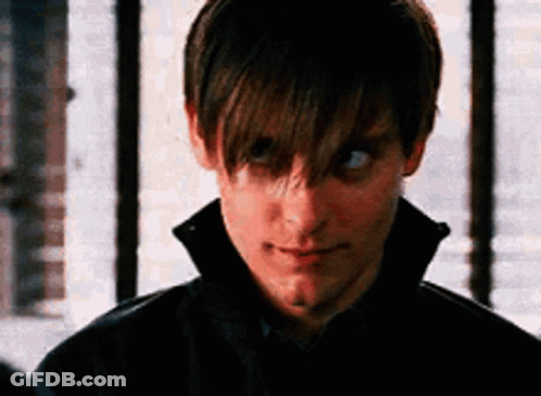 A Close Up Of A Man 'S Face With A Black Jacket On Looking At The Camera . GIF
