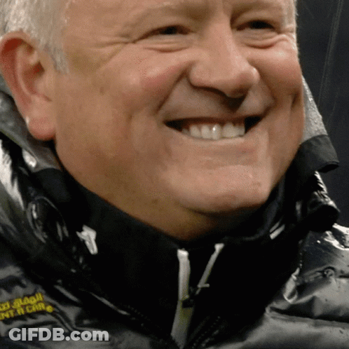 A Close Up Of A Man 'S Face With A Black Jacket That Says ' South China ' On The Front GIF