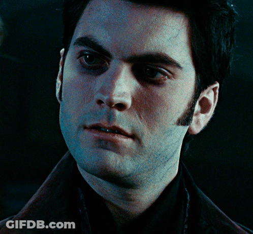 A Close Up Of A Man 'S Face With A Black Shirt On GIF