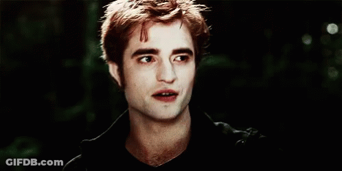 A Close Up Of A Man 'S Face With A Black Shirt On And A Dark Background . GIF