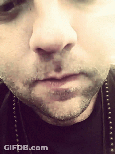 A Close Up Of A Man 'S Face With A Black Shirt On GIF