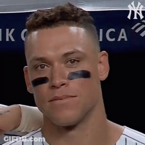 A Close Up Of A Man 'S Face With A Black Stripe On His Nose . GIF