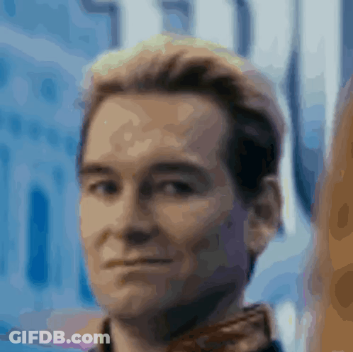 A Close Up Of A Man 'S Face With A Blue Background And A Blurred Background . GIF