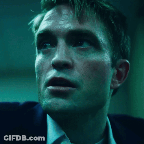 A Close Up Of A Man 'S Face With A Blue Background GIF