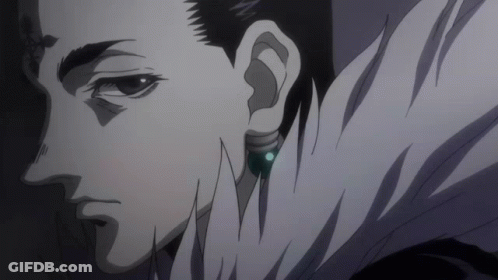 A Close Up Of A Man 'S Face With A Blue Earring In His Right Ear GIF