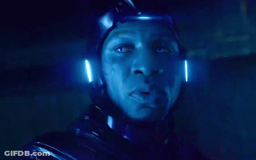 A Close Up Of A Man 'S Face With A Blue Light Behind Him GIF