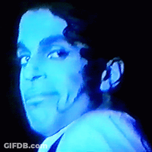 A Close Up Of A Man 'S Face With A Blue Light Shining On It GIF
