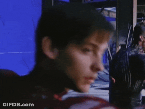 A Close Up Of A Man 'S Face With A Blue Screen Behind Him GIF