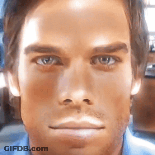 A Close Up Of A Man 'S Face With A Blue Shirt GIF