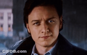 A Close Up Of A Man 'S Face With A Blue Shirt And A Blue Jacket . GIF