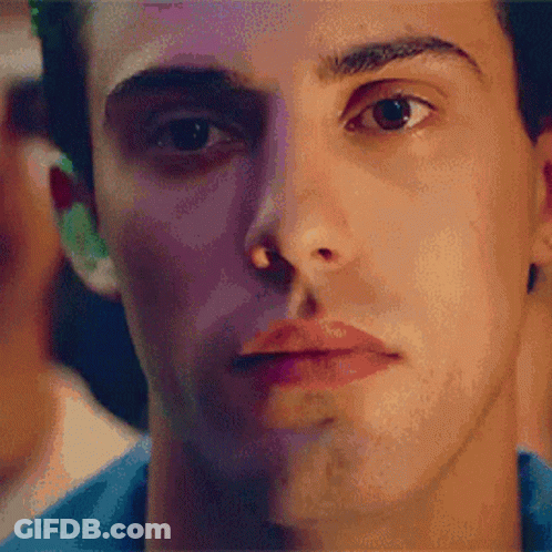 A Close Up Of A Man 'S Face With A Blue Shirt GIF