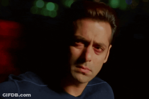 A Close Up Of A Man 'S Face With A Blue Shirt On GIF