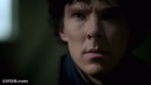 A Close Up Of A Man 'S Face With A Blue Shirt On GIF