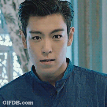 A Close Up Of A Man 'S Face With A Blue Shirt On GIF