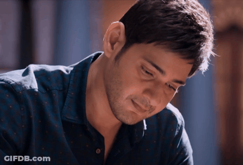 A Close Up Of A Man 'S Face With A Blue Shirt On GIF