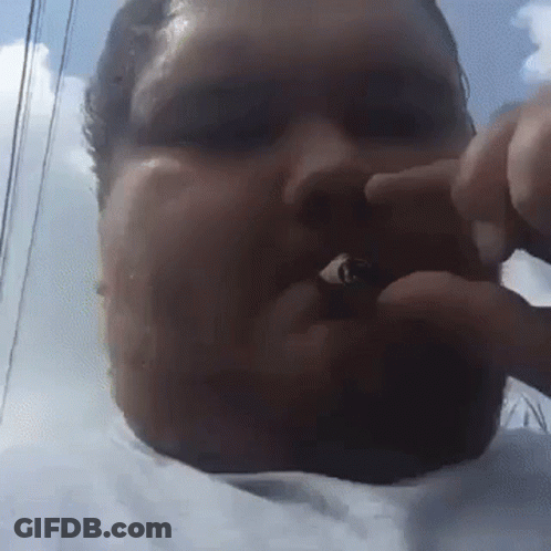 A Close Up Of A Man 'S Face With A Blue Sky Behind Him GIF