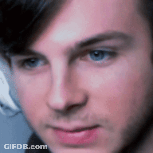 A Close Up Of A Man 'S Face With A Blurred Background GIF