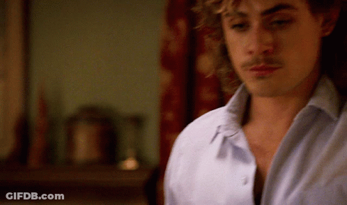 A Close Up Of A Man 'S Face With A Blurred Background GIF