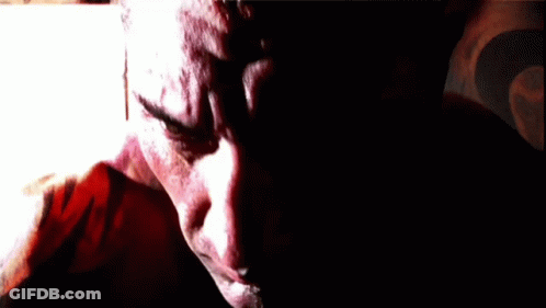 A Close Up Of A Man 'S Face With A Blurred Background GIF