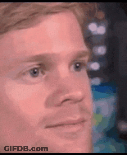 A Close Up Of A Man 'S Face With A Blurred Background . GIF