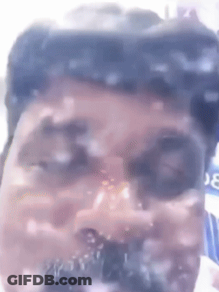 A Close Up Of A Man 'S Face With A Blurred Background And A Bottle Of Coca Cola In The Background GIF