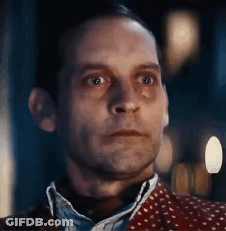 A Close Up Of A Man 'S Face With A Blurred Background And A Polka Dot Shirt . GIF