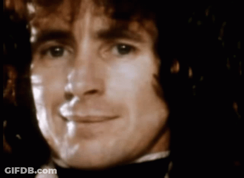 A Close Up Of A Man 'S Face With A Blurred Background GIF