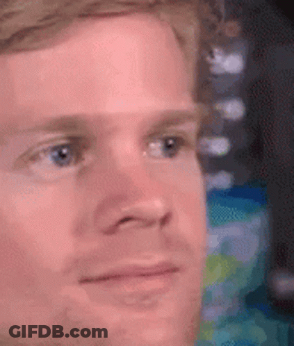 A Close Up Of A Man 'S Face With A Blurred Background . GIF